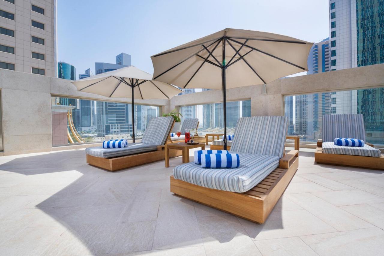 Wyndham Grand Doha West Bay Beach Exterior foto The pool deck at the hotel